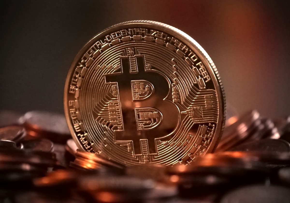 Warning sign highlighting Bitcoin tax scam risks with cryptocurrency symbols and tax documents in the background.